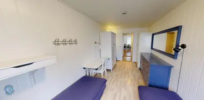 a room with a table and a mirror and purple chairs at Hardanger Hostel B&B in Lofthus