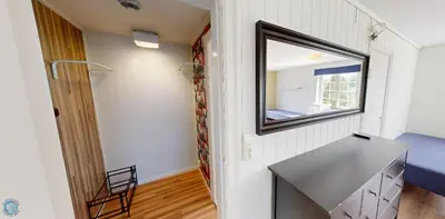 a small room with a mirror and a table at Hardanger Hostel B&B in Lofthus