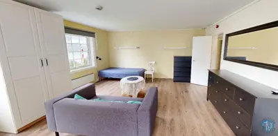 a living room with a couch and a chair at Hardanger Hostel B&B in Lofthus