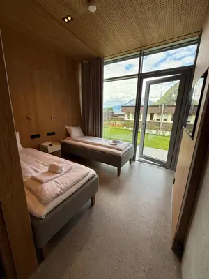 a bedroom with two beds and a large window at Kinsarvik Camping in Kinsarvik