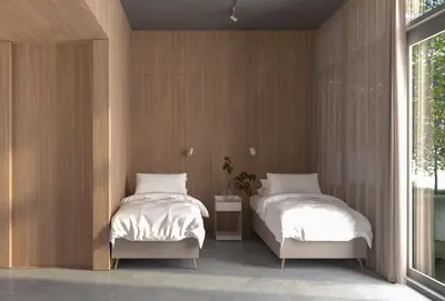 two beds in a room with wooden walls at Kinsarvik Camping in Kinsarvik