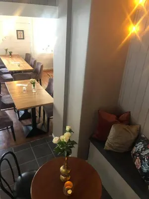 a living room with a table and a couch at Stryn Kaffebar & Vertshus in Stryn