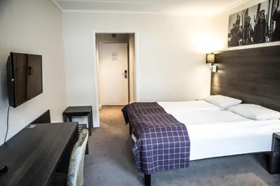 a hotel room with a bed and a table at Geilo Hotel in Geilo
