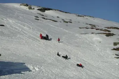 a group of people walking down a snow covered slope at Bergsjøstølen Fjellstue in Bergsjostolen