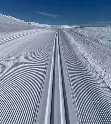 an empty road covered in snow in a field at Bergsjøstølen Fjellstue in Bergsjostolen