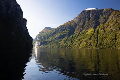 a view of a lake in front of a mountain at Geirangerfjorden Feriesenter in Geiranger