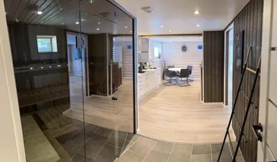 a glass door leading to a kitchen and a dining room at Jolster sauna apartments in Skei