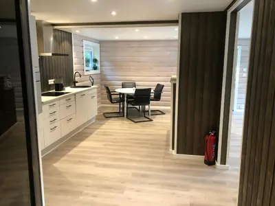 a kitchen and dining room with a table and chairs at Jolster sauna apartments in Skei