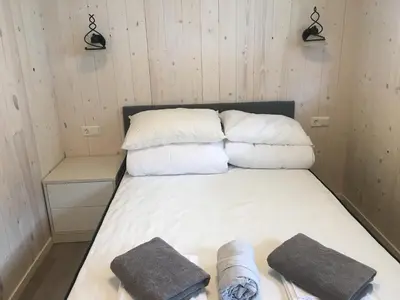 a bed in a room with three pillows on it at Jolster sauna apartments in Skei