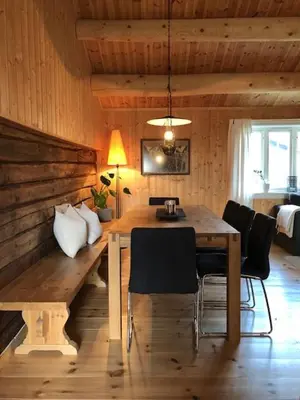 a dining room with a wooden table and chairs at Svenskveien 23b in Røros