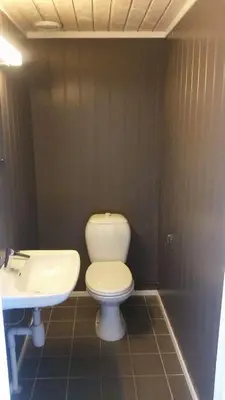 a bathroom with a toilet and a sink at Skei Apartments in Svingvoll