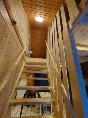 a staircase in a cabin with wooden walls at Trollbu Aabrekk gard in Briksdalsbre