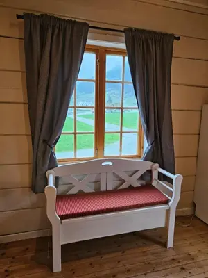a window with a bench in front of it at Trollbu Aabrekk gard in Briksdalsbre