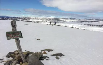 a sign on top of a snow covered hill at Stunning Home In Sjusjøen With Kitchen in Sjusjøen