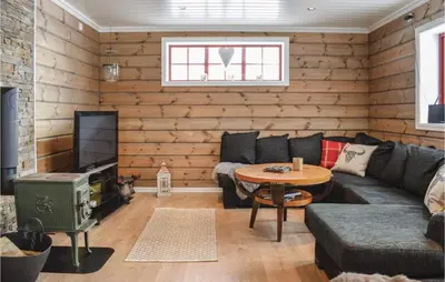 a living room with a couch and a table at Cozy Home In Sjusjøen With Kitchen in Sjusjøen