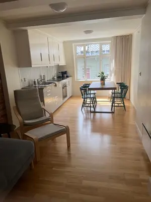 a kitchen and living room with a table and chairs at Blue House Odda in Odda