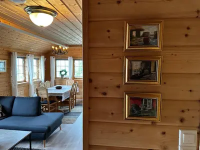 a living room and dining room with wood paneling at Faleide Panorama Private Fjord View Cabin with Large Terrace in Stryn