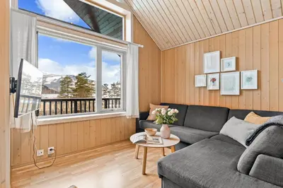 a living room with a couch and a window at Mikkelparken Ferietun in Kinsarvik