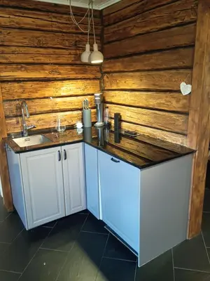 a kitchen with a sink and a wooden wall at Presterudveien 125 in Vikersund