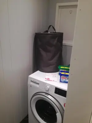 a washing machine with a bag on top of it at Presterudveien 125 in Vikersund