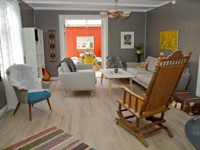 a living room with a couch and a chair at Kårstua - Austrått Agroturisme in Austrått