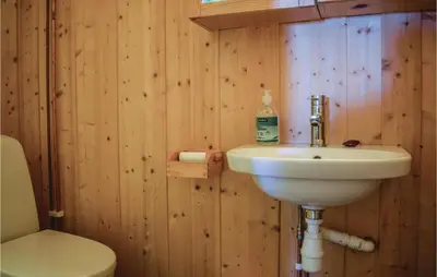 a bathroom with a sink and a toilet at 5 Bedroom Stunning Home In Noresund in Noresund