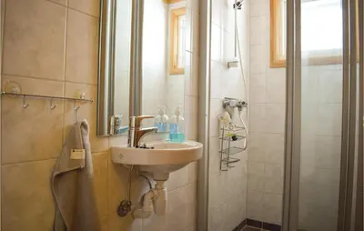 a bathroom with a sink and a shower at 5 Bedroom Stunning Home In Noresund in Noresund