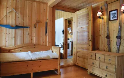 a log cabin bedroom with a bed and a closet at 5 Bedroom Stunning Home In Noresund in Noresund