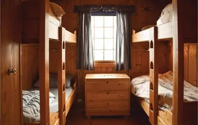 a bedroom with two bunk beds and a window at 5 Bedroom Stunning Home In Noresund in Noresund