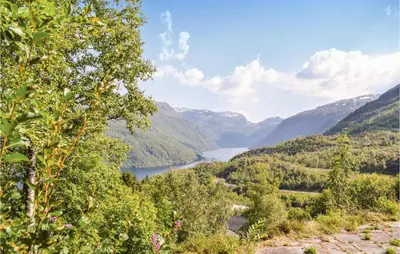 a view of a river in a valley with mountains at Four-Bedroom Holiday Home In Roldal in Røldal