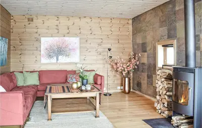 a living room with a red couch and a fireplace at Four-Bedroom Holiday Home In Roldal in Røldal
