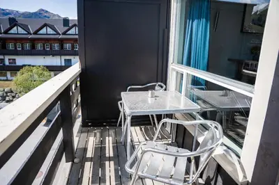a table and two chairs sitting on a balcony at Hemsedal Cafe Skiers Lodge in Hemsedal