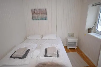 a bedroom with a white bed with towels on it at Apartment between Ustaoset and Geilo in Geilo