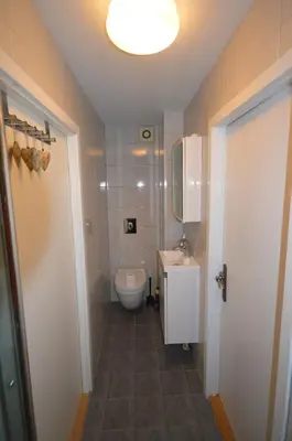 a small bathroom with a toilet and a sink at Apartment between Ustaoset and Geilo in Geilo