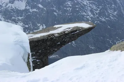 a rock sticking out of the snow on a mountain at Røldalstunet Overnatting in Røldal