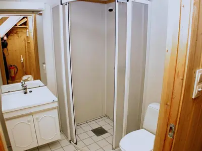 a bathroom with a shower and a toilet and a sink at Hunderfossen Apartments in Hafjell