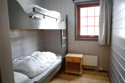 a small room with a bunk bed and a window at Hunderfossen Apartments in Hafjell