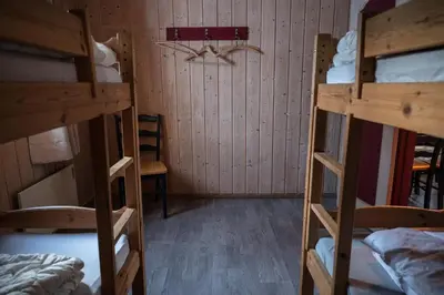 a room with three bunk beds and a wall at Hytter Dombås in Dombås