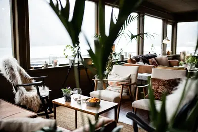 a restaurant with chairs and tables and windows at Fjærland Fjordstove Hotell - Huseby Hotelldrift AS in Fjarland