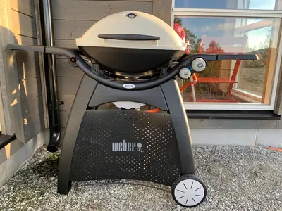 a grill sitting on a stand in front of a window at Trysilsetra 40 in Trysil