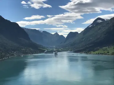 a river in the middle of a valley with mountains at Olden Fjord Apartments in Olden