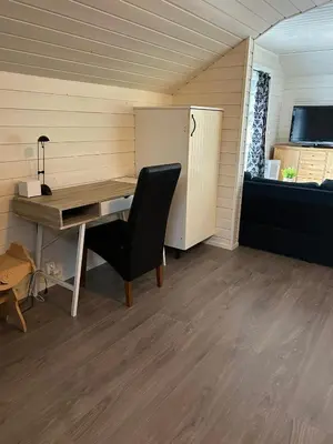 a room with a desk and a chair and a bed at Loftesnes in Sogndal