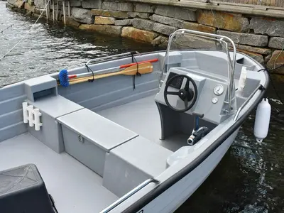 a small boat is docked in the water at 6 person holiday home in Onarheim in Onarheim