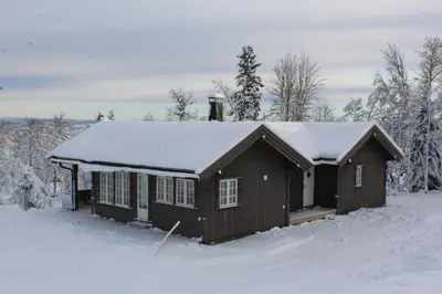 a small cabin with snow on the roof at Bergestua - 4 bedroom cabin in Gol