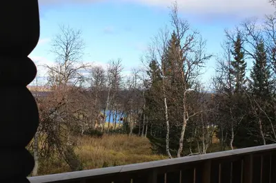 a view of a field from a deck with trees at Bergestua - 4 bedroom cabin in Gol