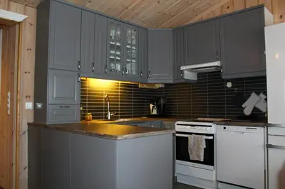 a kitchen with gray cabinets and white appliances at Bergestua - 4 bedroom cabin in Gol