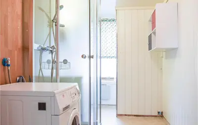a laundry room with a washer and dryer at 4 Bedroom Beautiful Home In Steinstø in Steinstø