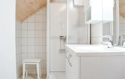 a white bathroom with a sink and a shower at Fjellstua C3, Leil 202 in Sjusjøen