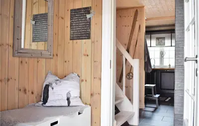 a room with wooden walls and a stair case at Three-Bedroom Holiday Home In Hovet in Hovet