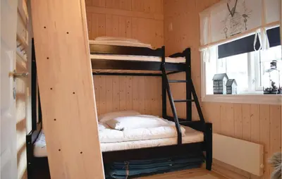 a room with two bunk beds in a room at Three-Bedroom Holiday Home In Hovet in Hovet